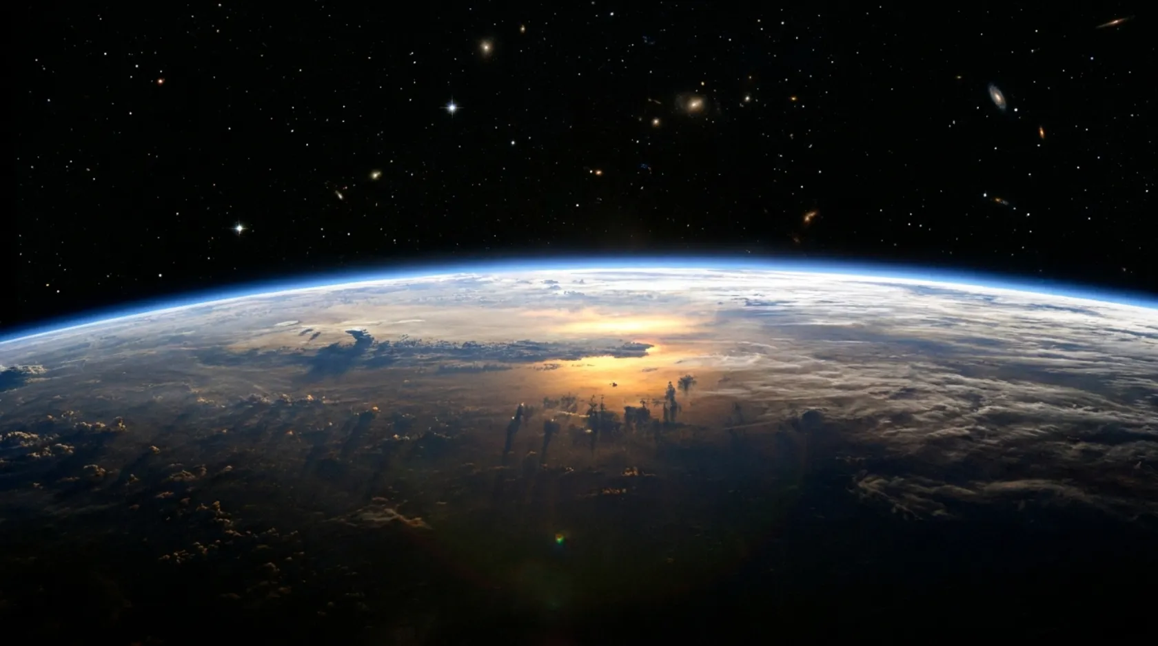 Earth's curvature seen from the edge of space, the thin blue line of the atmosphere against black.
